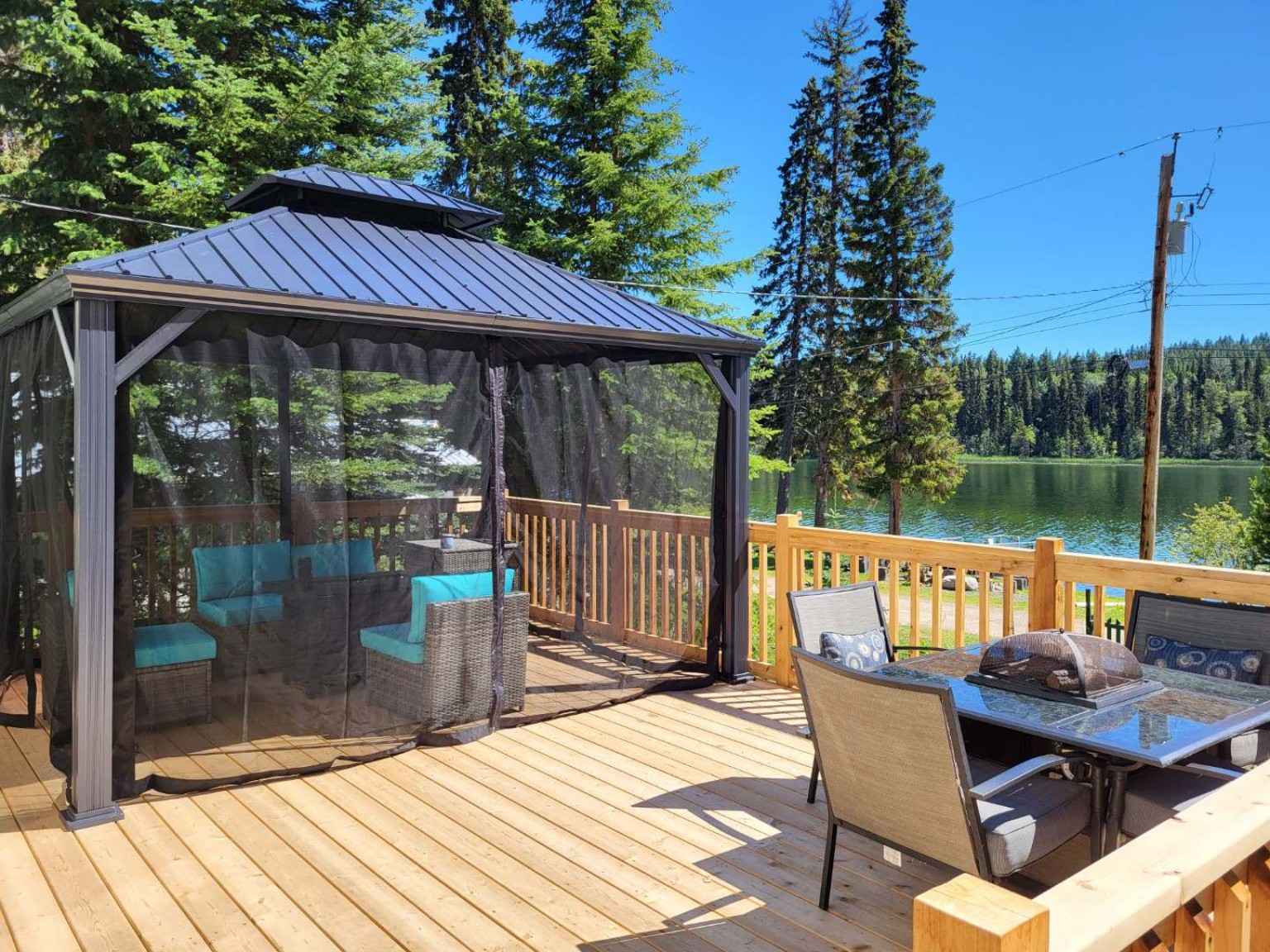 Finished lakefront deck with outdoor seating and screened gazebo