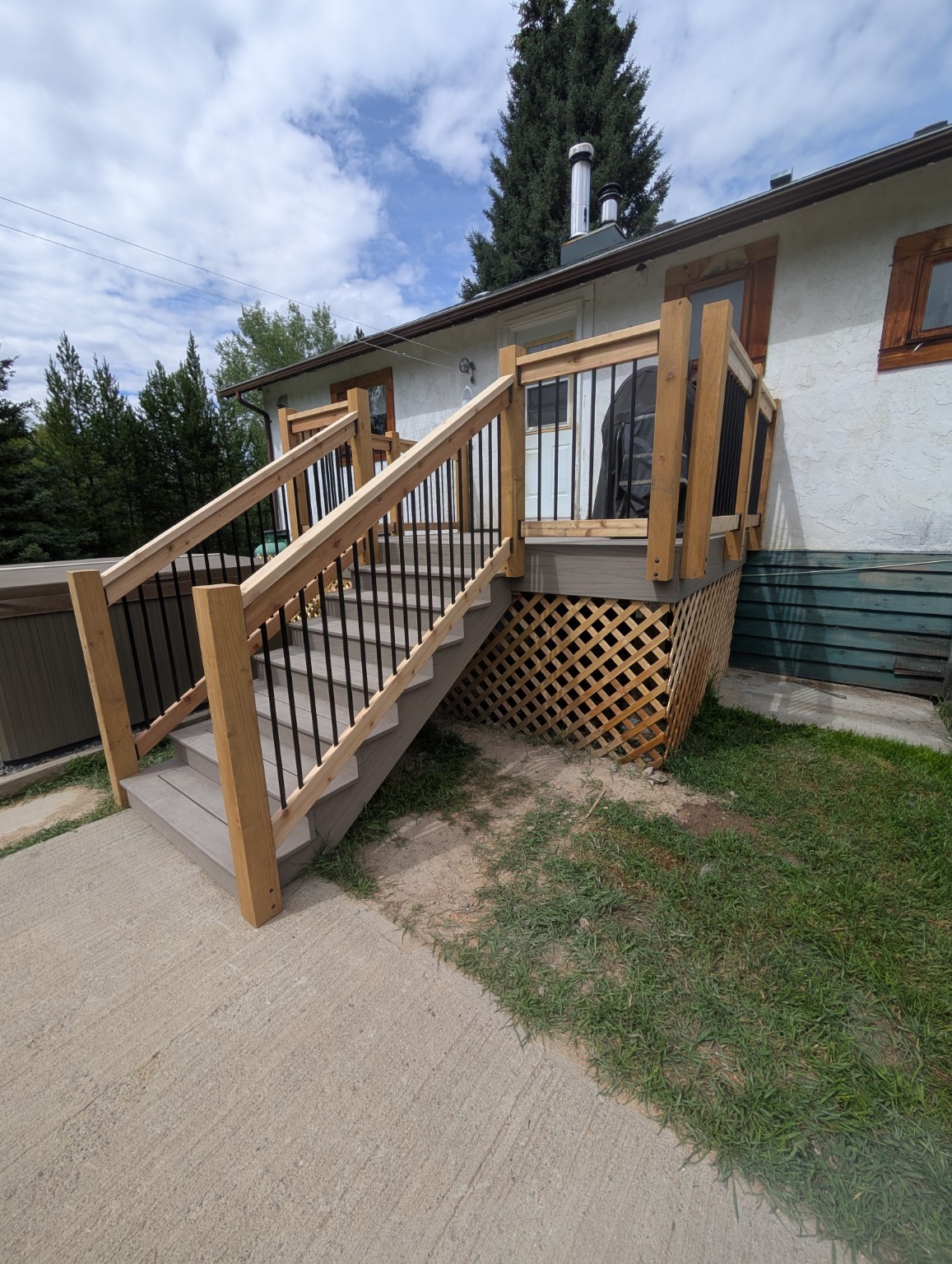 Composite deck stairs and railings beside the home