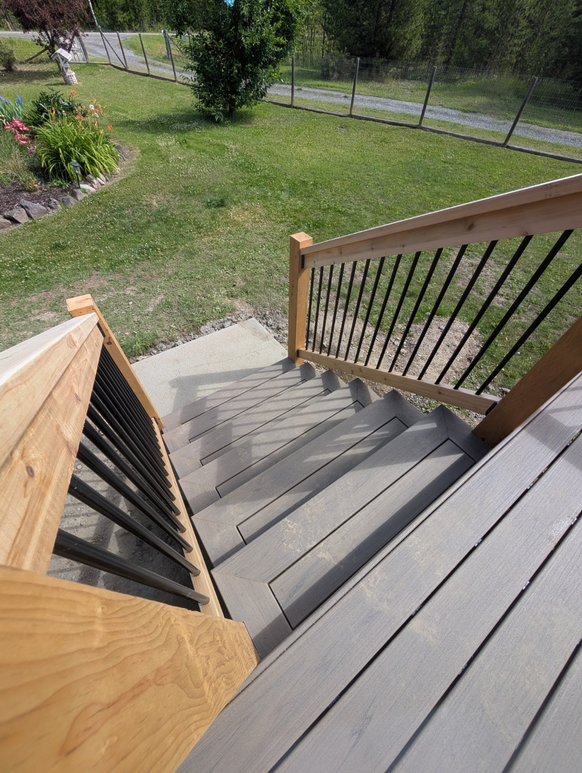 Close view of composite stairs and wood railing